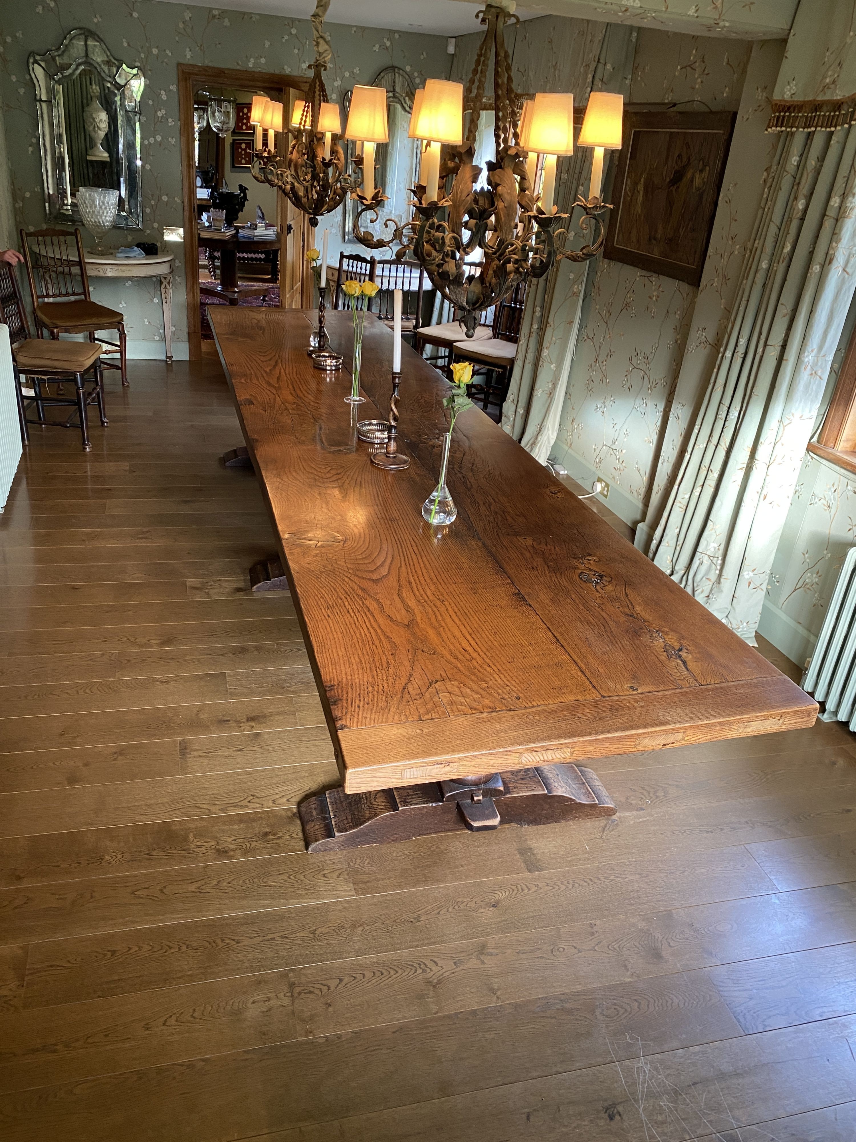 An impressively large 17th century style oak refectory table, with twin plank top on triple baluster supports and trestle foot, width 430cm depth 99cm height 74cm